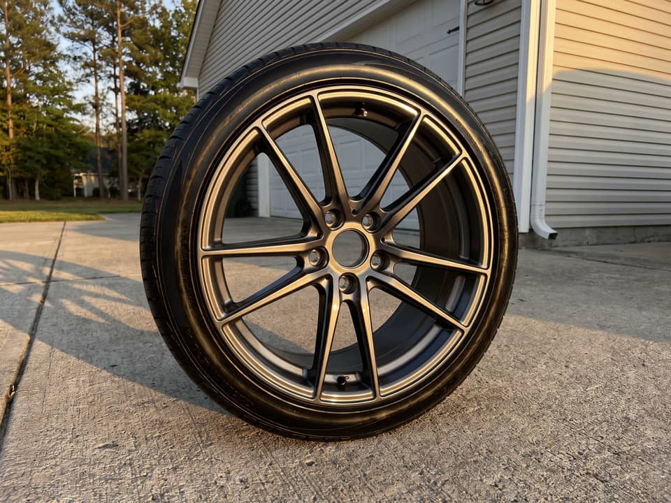 Cleaned alloy wheel with brake dust removed from the barrel and the tire dressed satin